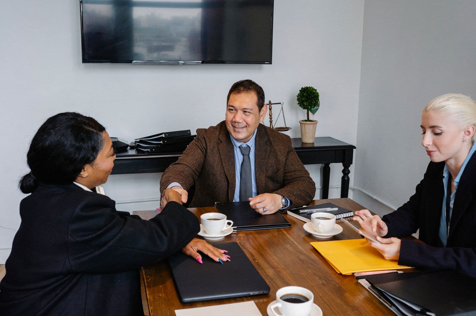 Business team shaking hands at the end of a meeting