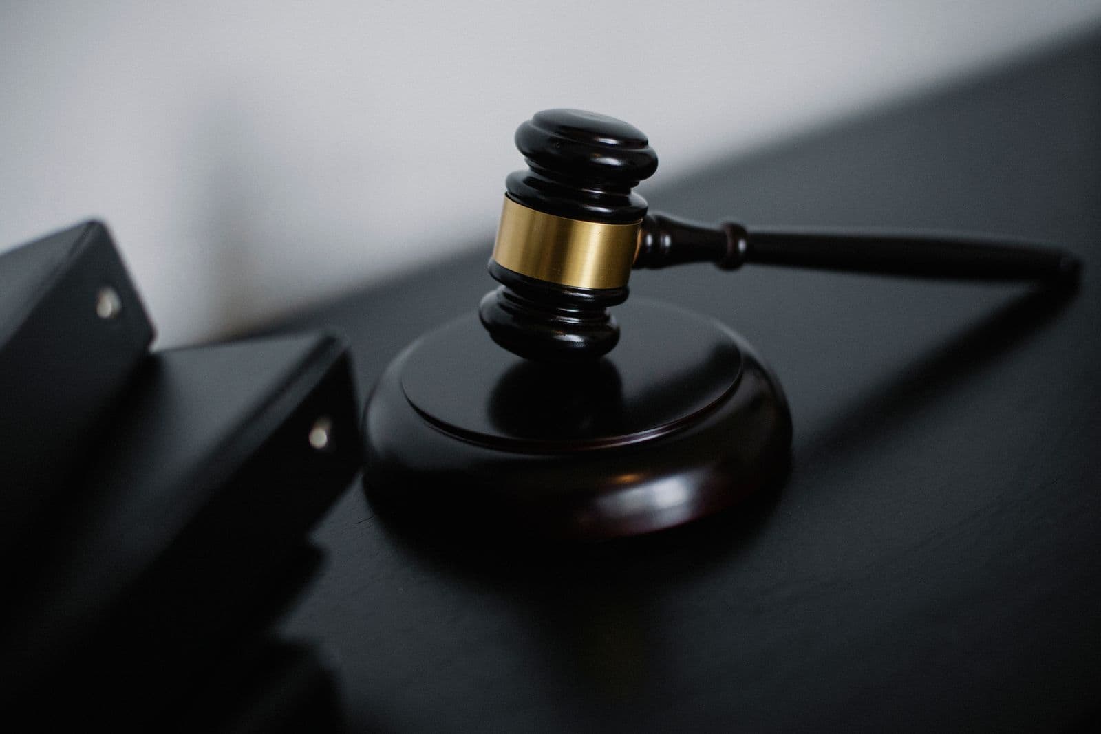 Wooden gavel on a dark desk