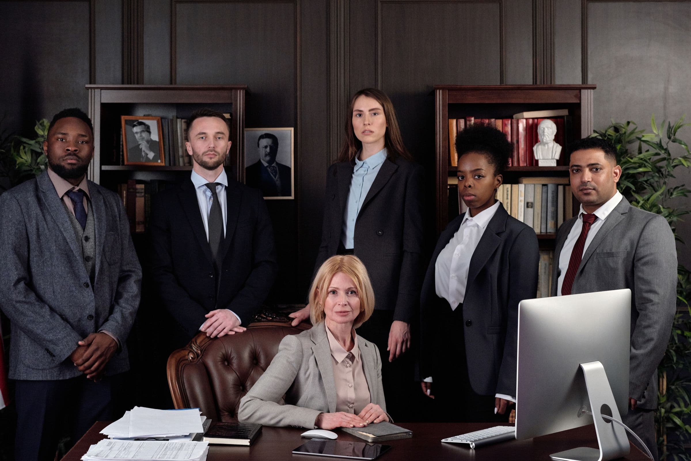 Whitmore Legal attorneys standing together in the firm's library