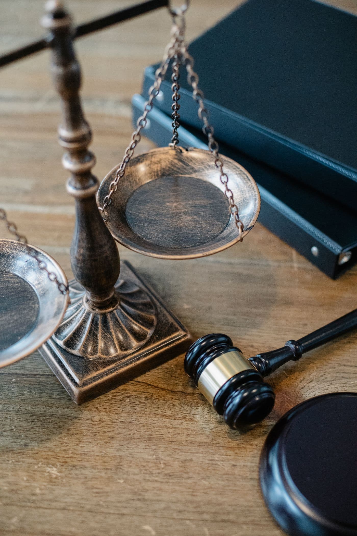 Scales of justice and law books beside a gavel