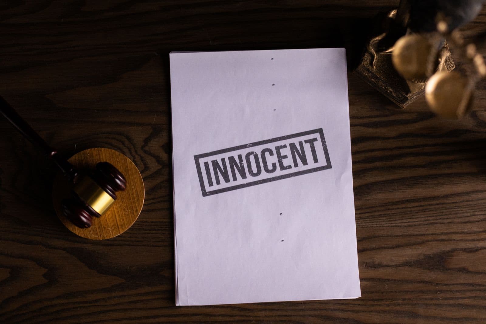 Legal document on a wooden desk next to a gavel